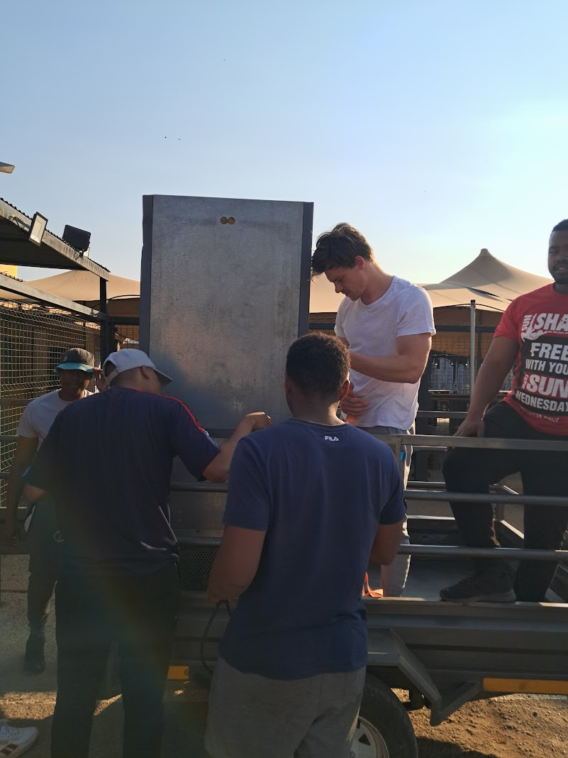 The POSITECH team deploying a vending machine